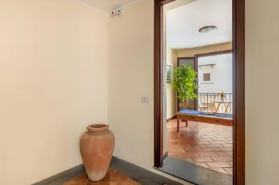 a large mirror in a room with a vase at GuestHost - Central Apartment Palermo in Palermo