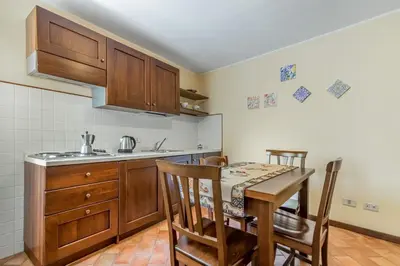 a kitchen with a table and chairs and a sink at GuestHost - Central Apartment Palermo in Palermo