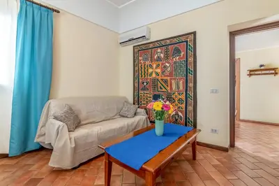 a living room with a couch and a table at GuestHost - Central Apartment Palermo in Palermo