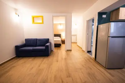 a living room with a couch and a refrigerator at Flat in center 2 in Palermo