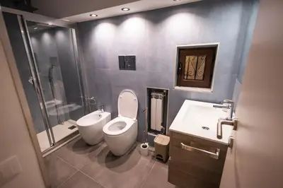 a bathroom with a toilet and a bidet and a sink at Flat in center 2 in Palermo
