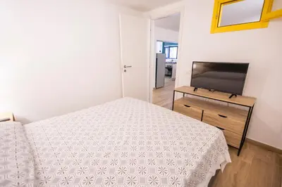 a bedroom with a bed and a flat screen tv at Flat in center 2 in Palermo