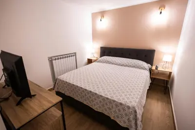 a bedroom with a bed and a flat screen tv at Flat in center 2 in Palermo
