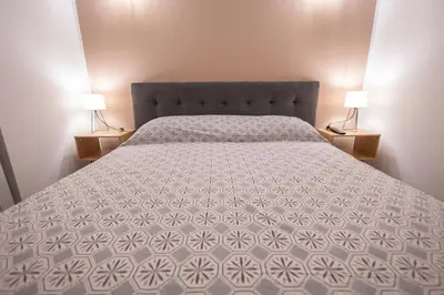 a bedroom with a bed and two lamps on tables at Flat in center 2 in Palermo