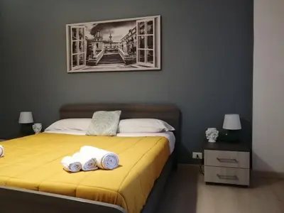 a bedroom with a bed with two towels on it at Dante091 in Palermo