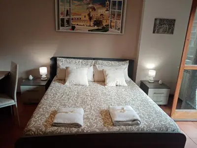a bedroom with a bed with two towels on it at Dante091 in Palermo