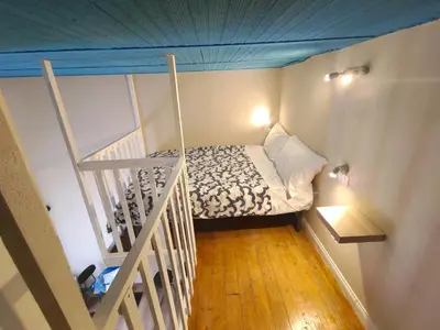 a small bedroom with a bed with a blue ceiling at Atypical Rooms in Palermo