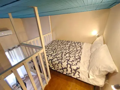 a small bedroom with a bed in a room at Atypical Rooms in Palermo