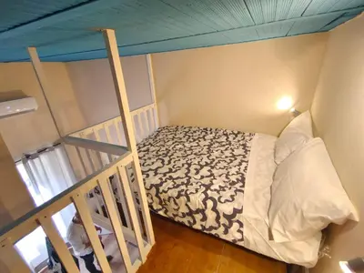 a bedroom with a bed in a room at Atypical Rooms in Palermo