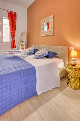 a blue and white bed in a room at VFH Blue Breeze holiday home in Porticello