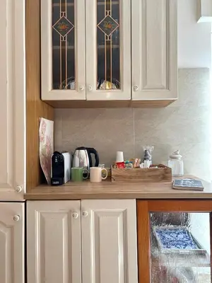 a kitchen with white cabinets and a counter top at La Casa del Sole in Corleone
