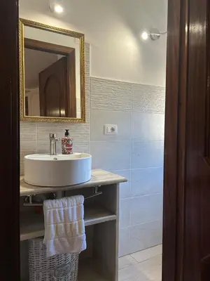 a bathroom with a sink and a mirror at La Casa del Sole in Corleone