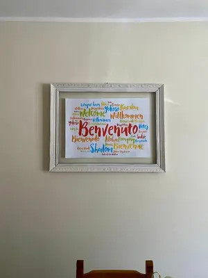 a framed picture on a wall with writing on it at La Casa del Sole in Corleone