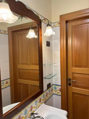 a bathroom with a mirror and a sink and a tub at da Mimì in San Vito lo Capo