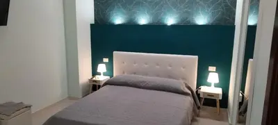 a bedroom with a white bed with two night stands at Suite Conte di Cavour in Palermo