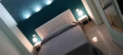 a bedroom with a bed with two lights on it at Suite Conte di Cavour in Palermo