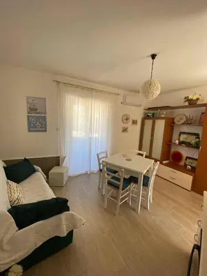 a living room with a table and a couch at Casa Bluet on the Sea in Balestrate