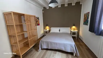 a bedroom with a bed and a book shelf at Sichilia House in Palermo