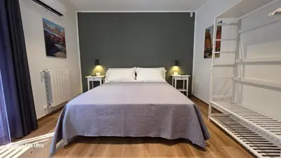 a bedroom with a bed and two night stands at Sichilia House in Palermo