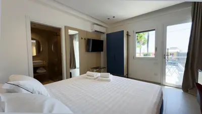 a bedroom with a white bed with towels on it at Regina Elena Luxury Apartments in Mondello