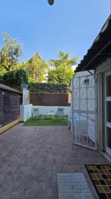a patio with a table and chairs next to a building at Apollo Suite in Palermo