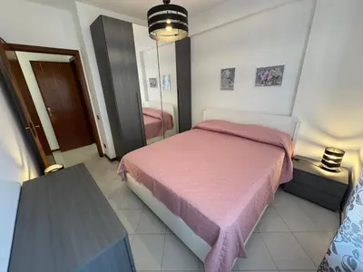 a bedroom with a pink bed and a mirror at Castelforte House in Palermo