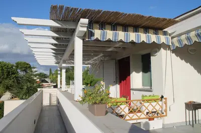 a balcony of a house with an awning at Baia del Sol Balestrate in Balestrate