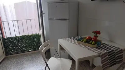 a table with a bowl of fruit on a balcony at Higgie House in Palermo