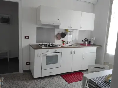 a kitchen with white cabinets and a stove top oven at Higgie House in Palermo