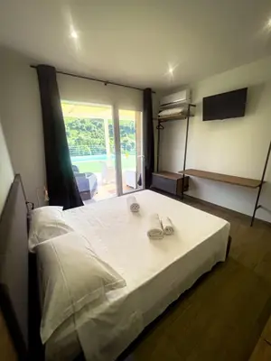 a bedroom with a large white bed with slippers on it at The Villa - Lascari Cefalu' in Lascari