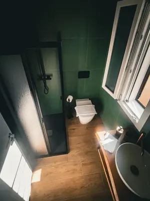 a bathroom with a toilet and a sink and a mirror at The Villa - Lascari Cefalu' in Lascari