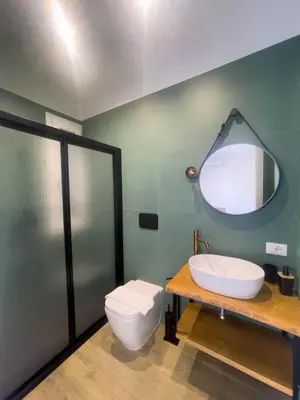 a bathroom with a toilet and a sink and a mirror at The Villa - Lascari Cefalu' in Lascari