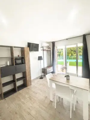 a dining room with a white table and a kitchen at The Villa - Lascari Cefalu' in Lascari