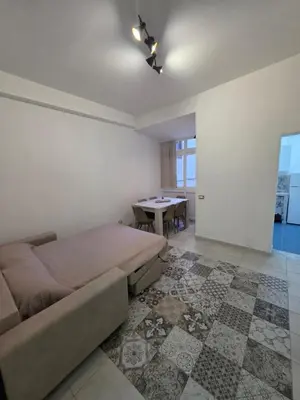 a bedroom with a large bed and a table at Vivaldi Holidays Historic house in the center of Palermo in Palermo