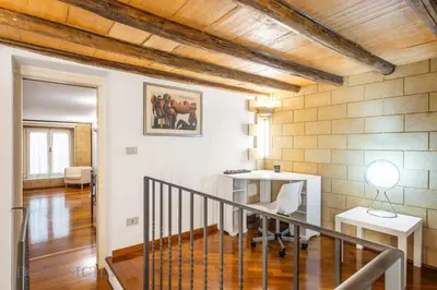 a hallway with a staircase in a building with wooden ceilings at La dimora di Aurora in Palermo