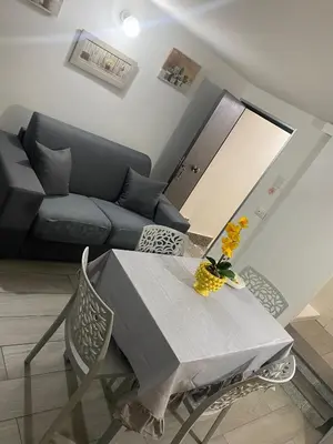 a living room with a table and a couch at La casetta dei Mori in Palermo