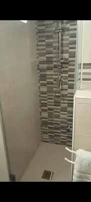 a shower in a bathroom with a glass door at La casetta dei Mori in Palermo