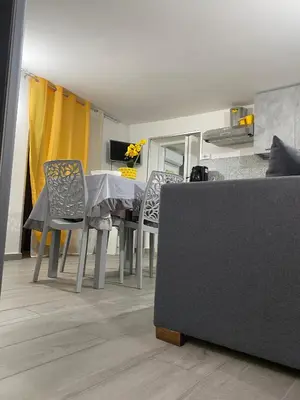 a living room with a table and chairs and a couch at La casetta dei Mori in Palermo
