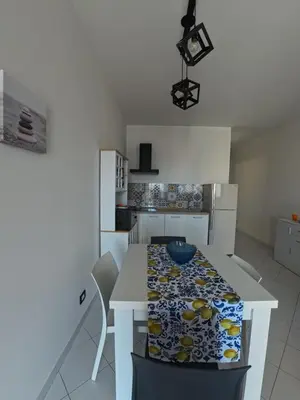 a kitchen with a table with a blue bowl on it at Ciatu di Suli in San Vito lo Capo