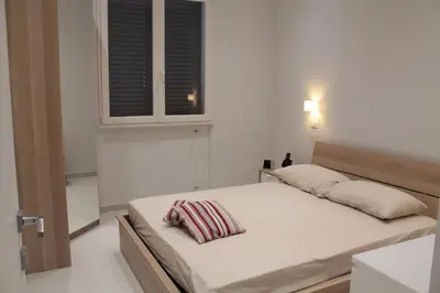 a small bedroom with a bed with a window at Casa Totino Mondello in Palermo