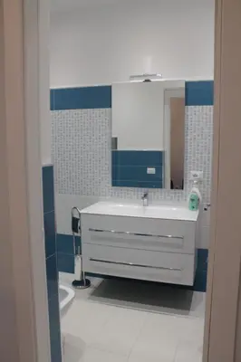 a bathroom with a sink and a mirror at Casa Carmela Mondello in Palermo