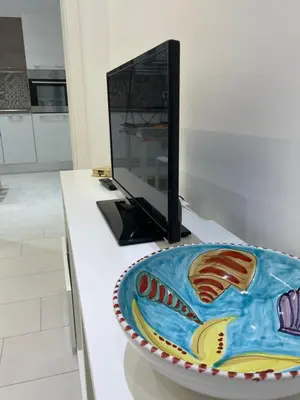a cake sitting on a desk with a computer monitor at Casa Carmela Mondello in Palermo