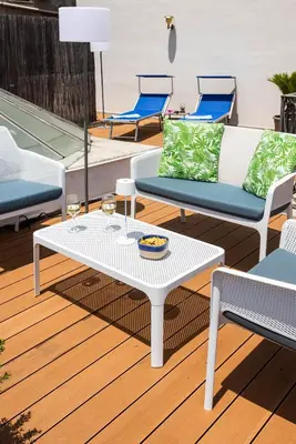 a white coffee table and chairs on a deck at Apartment with 2 Terraces near Teatro Massimo in Palermo
