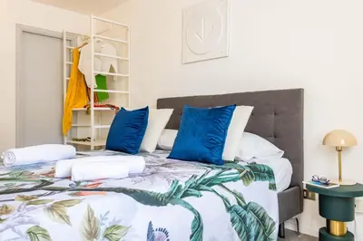 a bedroom with a large bed with blue pillows at Apartment with 2 Terraces near Teatro Massimo in Palermo