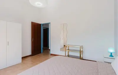 a white room with a bed and a table at Stunning Apartment In Balestrate in Balestrate