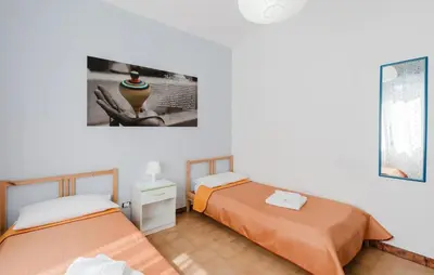 a room with two beds and a picture on the wall at Stunning Apartment In Balestrate in Balestrate