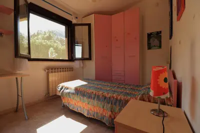 a small bedroom with a bed and a window at Villa Belorizzonte - Relax & Sea in Mandra Capreria