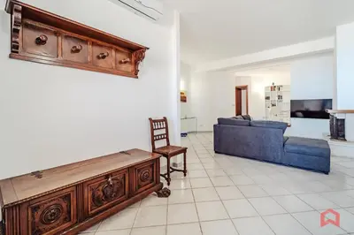 a living room with a blue couch and a table at Delizioso Appartamento in villa & Piscina Privata in Trabia