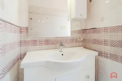 a bathroom with a white sink and a mirror at Delizioso Appartamento in villa & Piscina Privata in Trabia