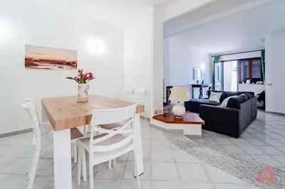 a living room with a table and a couch at Delizioso Appartamento in villa & Piscina Privata in Trabia